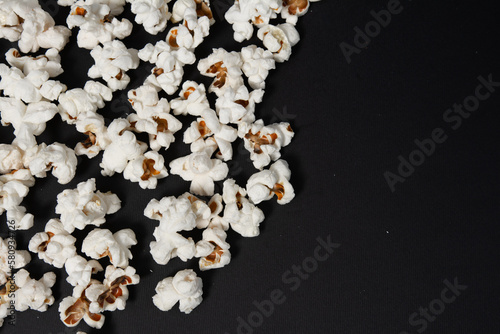 fried popcorn on a black background close-up  ready-to-eat food