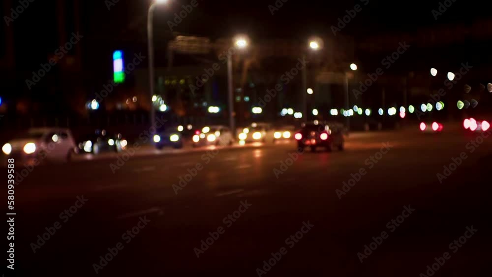night traffic on a busy city street.many cars drive with headlights on at night on city roads.blurred defocused video. night traffic on a busy city street.many cars drive with headlights on at night on city roads.blurred defocused video.