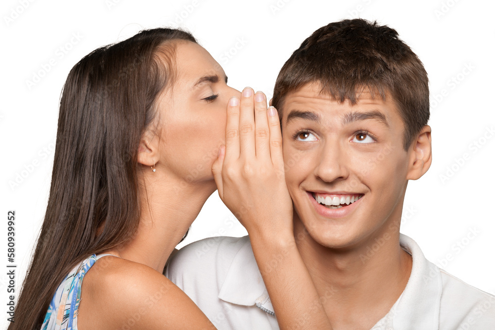 Portrait of young woman telling a secret to a man Portrait of young woman telling a secret to a man