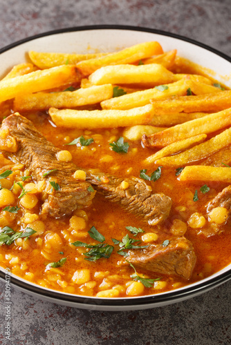 Khoresh Gheymeh Beef and yellow split pea stew with roasted potatoes closeup on a plate on the table. Vertical photo