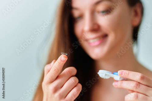 Young woman using soft contact lenses instead of glasses