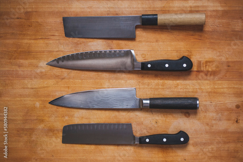 Overhead close-up of various knives on cutting board photo