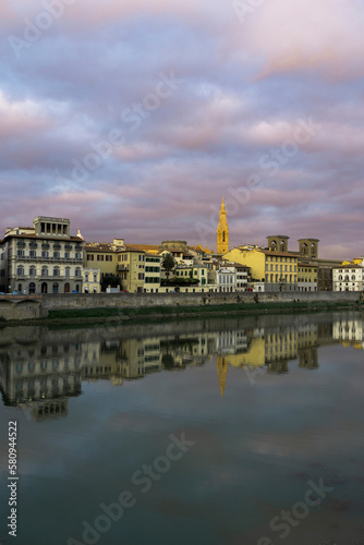 Scuola del Cuoio by Arno river against cloudy sky during sunset in city photo