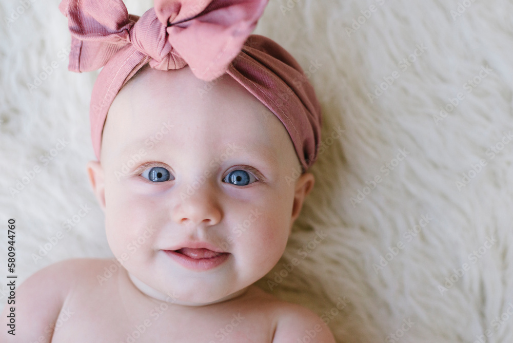Close-up portrait of cute baby girl lying on rug Close-up portrait of cute baby girl lying on rug