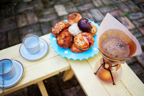 High angle view of coffee with desserts on wooden table at backyard photo