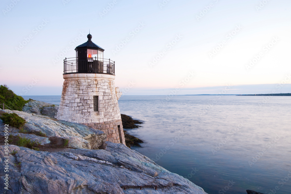 © Cavan Images - Lighthouse at Narragansett Bay of Rhode Island against clear sky during sunset