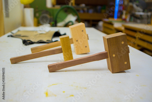 Wooden mallets on table in workshop photo