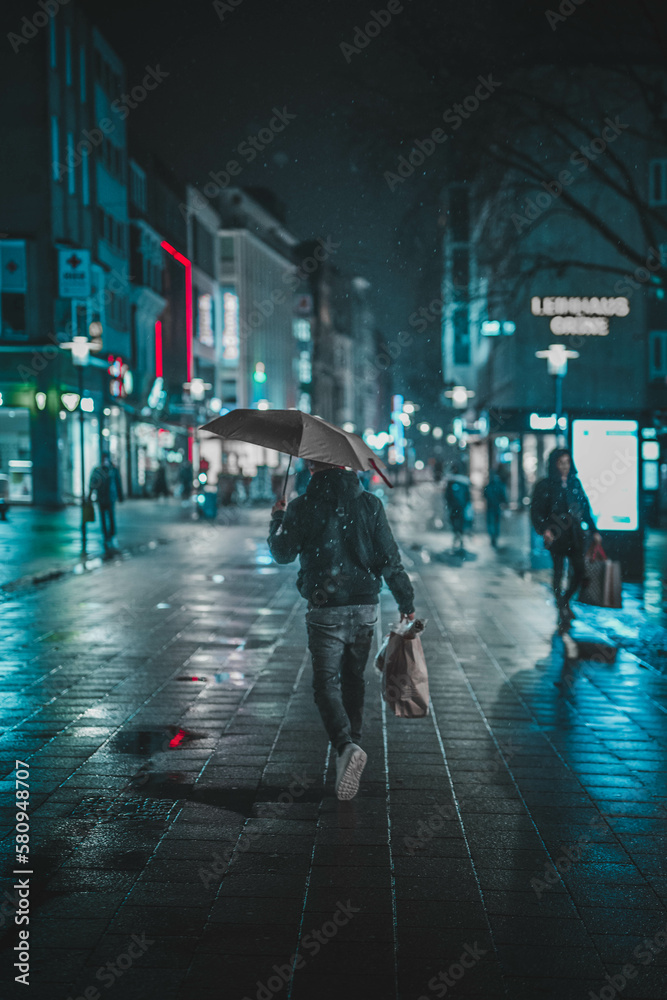 A downtown shopping street in the rain