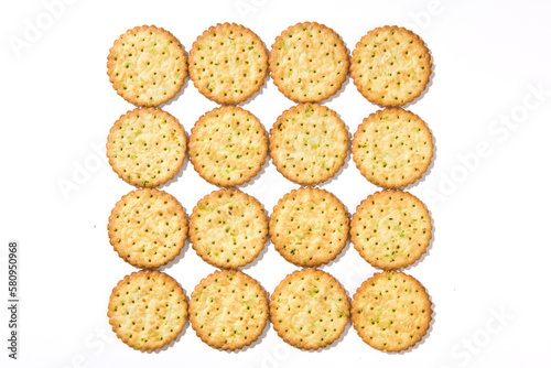 Heap of round thin crispy biscuits isolated on white background.