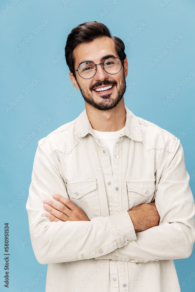 Portrait of a stylish man smile with teeth in glasses for farsightedness and myopia, on a blue background in a white T-shirt, fashionable clothing style, space space Portrait of a stylish man smile with teeth in glasses for farsightedness and myopia, on a blue background in a white T-shirt, fashionable clothing style, space space