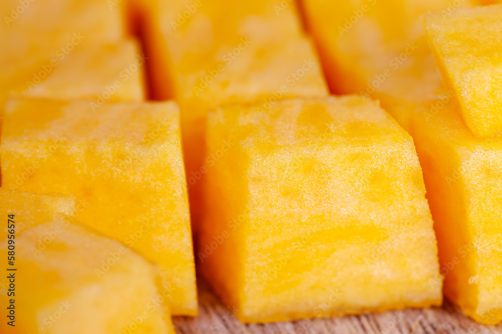 Sweet ripe orange pumpkin is sliced on the table