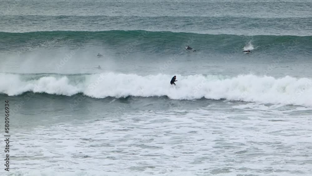 Surfer with helmet doing Turn On Blue Wave and doing re-entry. Cascais, Portugal. Surfer with helmet doing Turn On Blue Wave and doing re-entry. Cascais, Portugal.