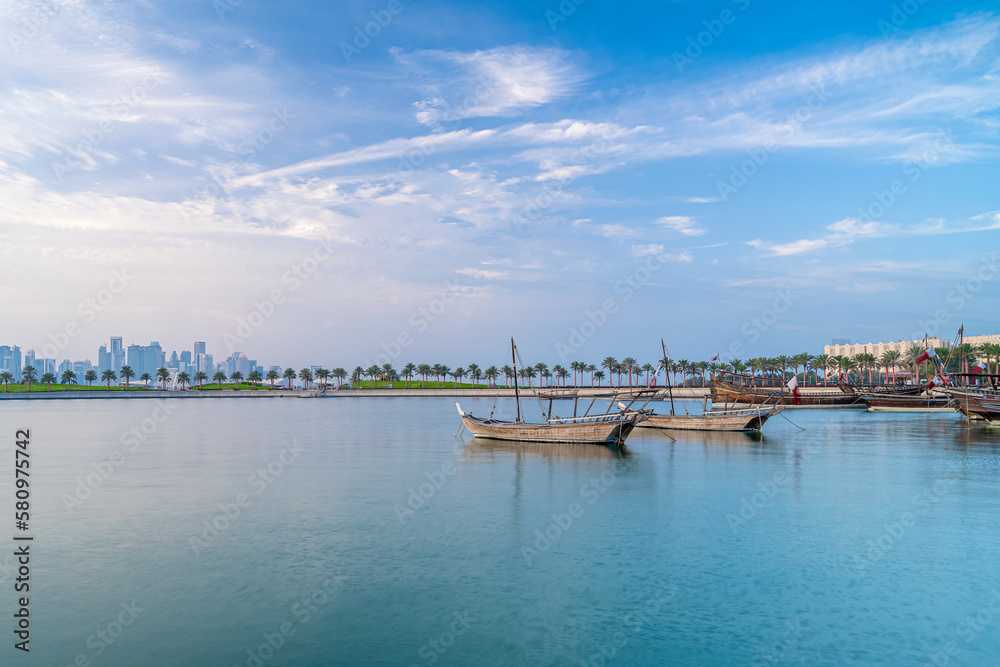 Doha skyline seen from MIA park and three dhow boats in the foreground.