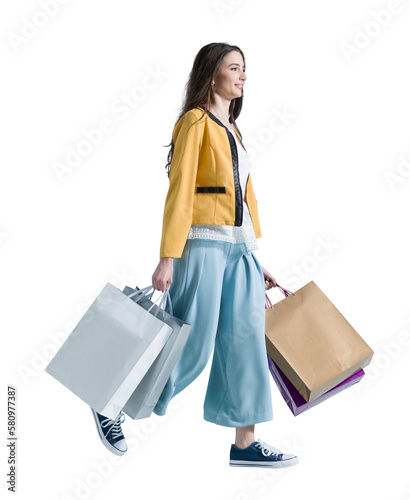 Smiling woman walking and holding shopping bags