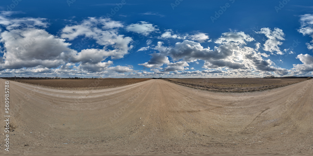 spherical 360 hdri panorama on gravel road with clouds and sun on blue sky in equirectangular seamless projection, use as sky replacement in drone panoramas, game development as sky dome or VR content