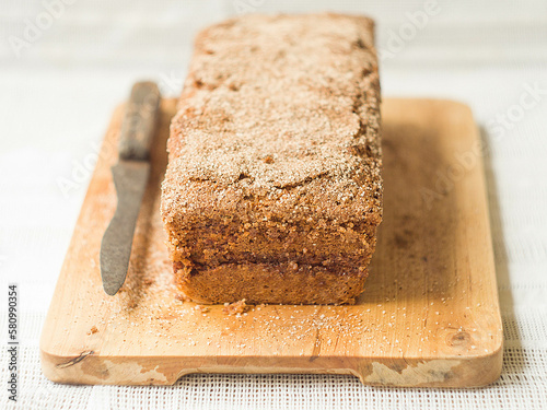 Brown butter pound cake with cinnamon on light concrete background. Top view, space for text.