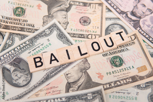 bailout inscription next to american dollars. Saving failing banks. Financial crisis concept photo