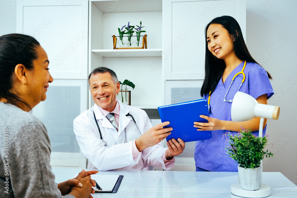 Fototapeta premium Female nurse taking file from doctor and smiling towards patient