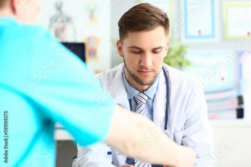 Doctor talks and listens to patient in clinic