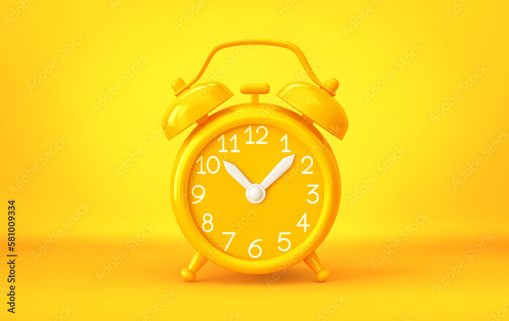 Yellow alarm clock on yellow background