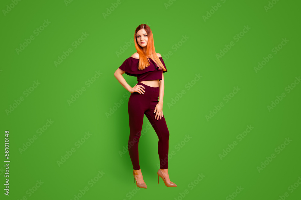Full size body length photo portrait of pretty cool attractive charming stunning lady standing on floor holding hand on waist isolated bright vivid background copy space Full size body length photo portrait of pretty cool attractive charming stunning lady standing on floor holding hand on waist isolated bright vivid background copy space