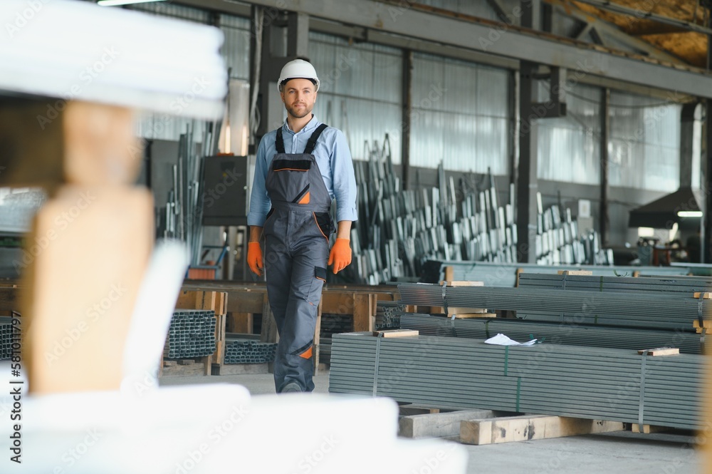 Profesional fabric worker. Metal processing plant. A worker at a metal profile warehouse.