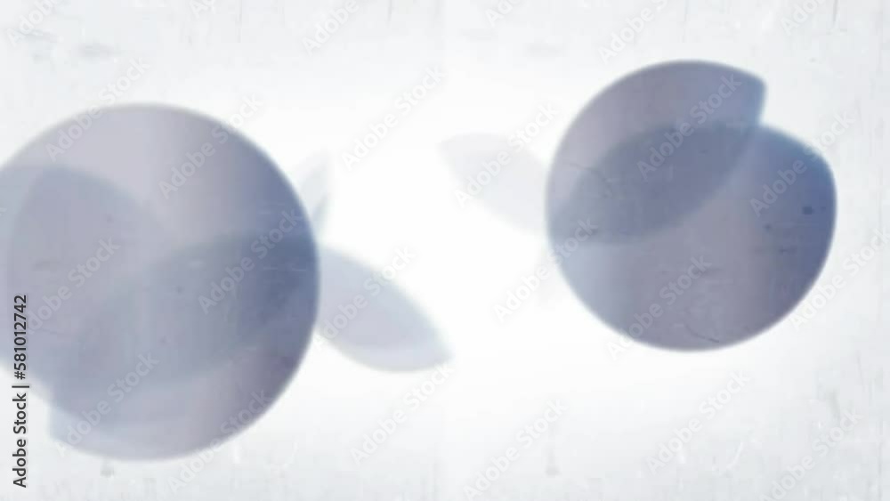 Floating light leaks and bokeh on grungy grey texture background. Stock