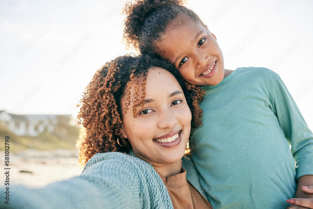 Selfie, smile and portrait of mother and girl by beach for bonding, relax and hug for quality time together. Summer, happy family and mom and child take picture by sea on holiday, vacation or weekend Selfie, smile and portrait of mother and girl by beach for bonding, relax and hug for quality time together. Summer, happy family and mom and child take picture by sea on holiday, vacation or weekend