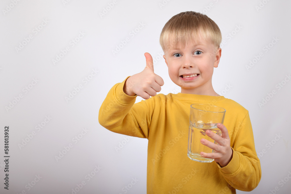 a boy in a yellow sweater, a child drinks water a boy in a yellow sweater, a child drinks water