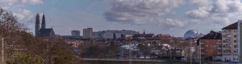 Hazy skyline over the districts Södermalm and Hammarby, churches and the Globen arena Avicii, a snowy sunny spring day in Stockholm