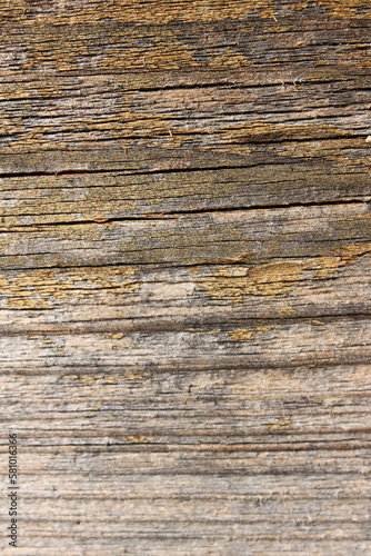 a weathered wooden board with horizontal cracks