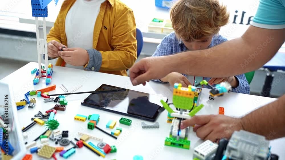 Robotics programming class. Children construct and code Robot. STEM ...