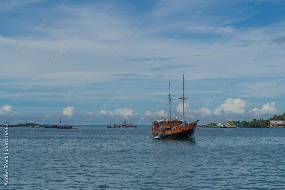 View from the ferry to Waisai at Sorong with cruises and tour boats, background blue sky, copy space View from the ferry to Waisai at Sorong with cruises and tour boats, background blue sky, copy space