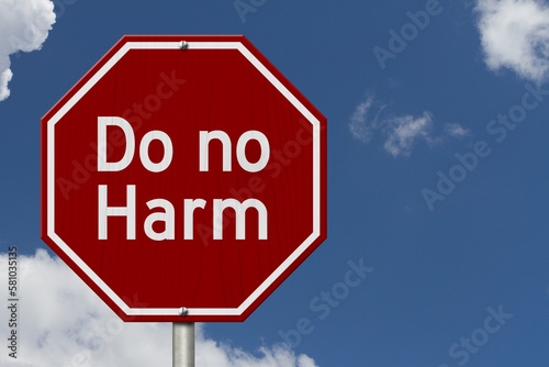 Do no harm message on red street stop sign