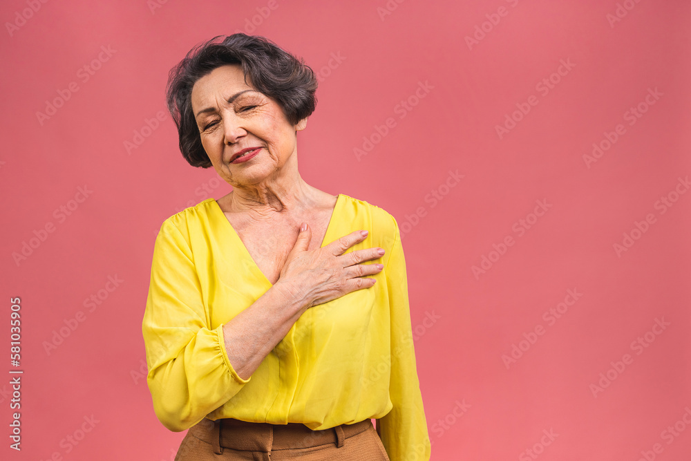 Heartache concept. Photo of elderly mature aged senior woman isolated over pink color background. Heartache concept. Photo of elderly mature aged senior woman isolated over pink color background.