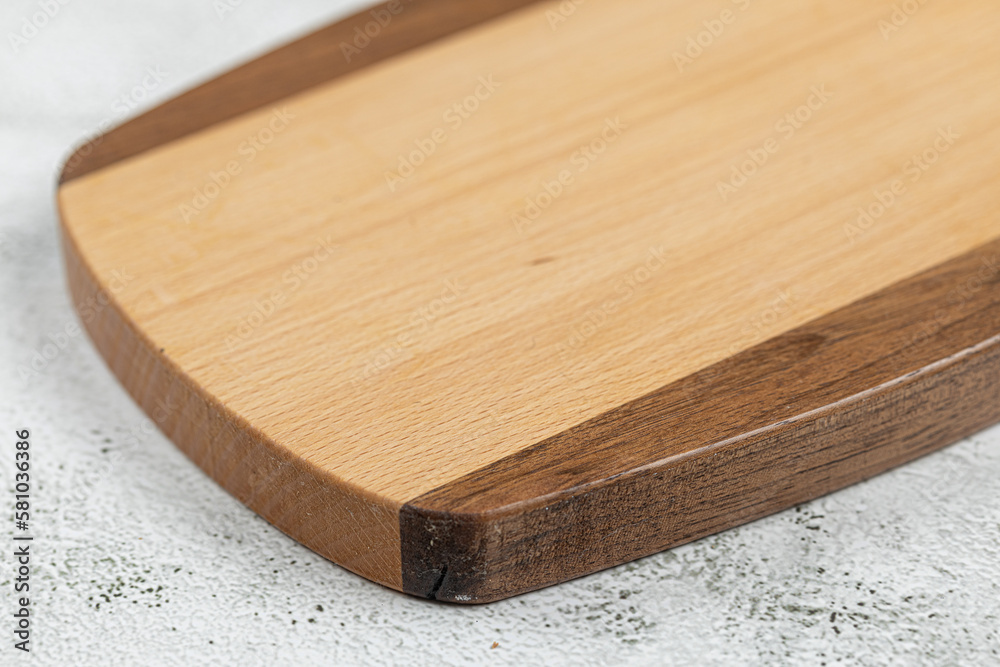 Empty wooden cutting board above grey marble background Empty wooden cutting board above grey marble background