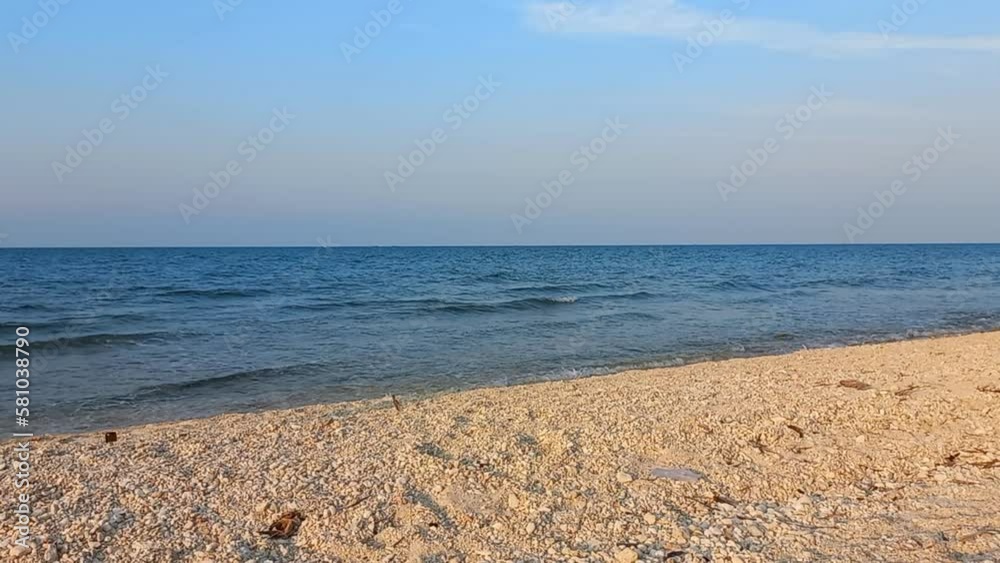Beautiful white sand seascape sunset beach with calm wave at Tuban, East Java, Indonesia. Tranquil coastline scenery Beautiful white sand seascape sunset beach with calm wave at Tuban, East Java, Indonesia. Tranquil coastline scenery