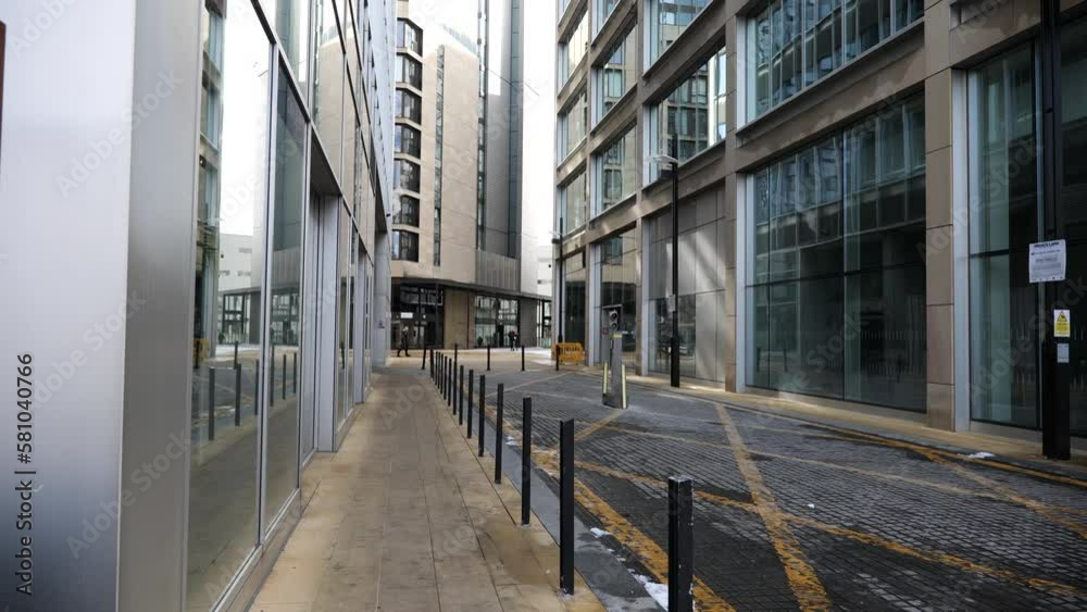 A city centre side street with impressive, glass fronted office buildings in an industrial setting. A city centre side street with impressive, glass fronted office buildings in an industrial setting.