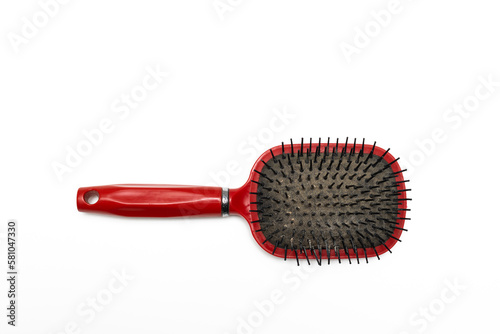 old red hairbrush with sticking out hair.