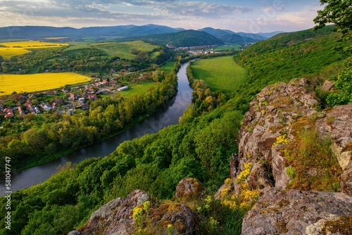 Fototapeta Naklejka Na Ścianę i Meble -  Spring landscape with blooming fields, green meadows and a meandering river in a valley under rocks. Discover the beauty of spring hiking
