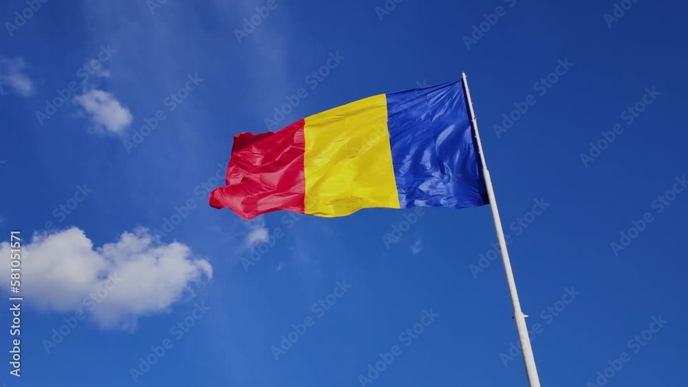 Colorful flag waving on a sunny windy day, blue sky, Romania Colorful flag waving on a sunny windy day, blue sky, Romania