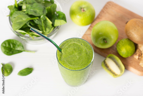 Healthy green smoothie with spinach in a jar mug isolated on white