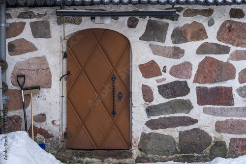 Wooden door of medieval stone church. photo