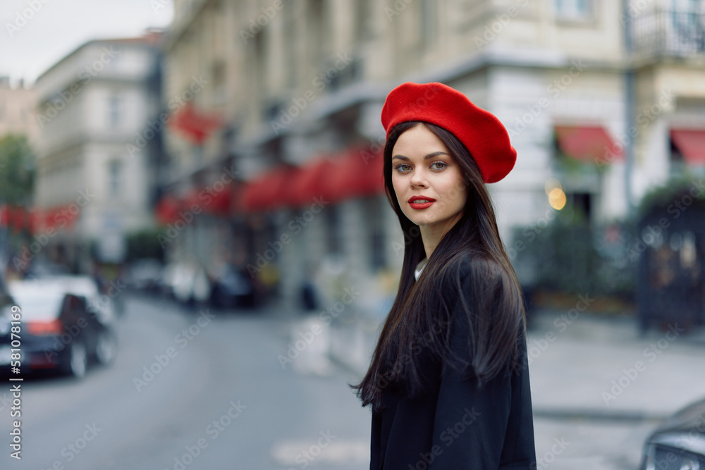 Fashion woman portrait beauty standing on the street in front of the city in stylish clothes with red lips and red beret, travel, cinematic color, retro vintage style, urban fashion lifestyle. Fashion woman portrait beauty standing on the street in front of the city in stylish clothes with red lips and red beret, travel, cinematic color, retro vintage style, urban fashion lifestyle.
