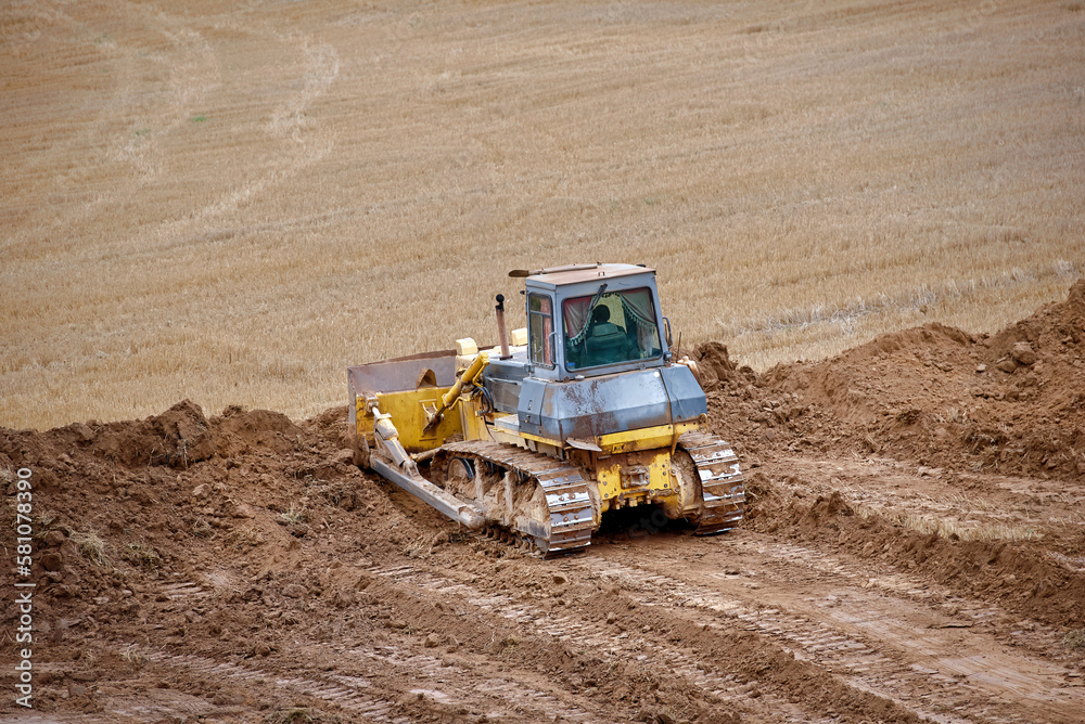 Dozer leveling ground, construction work. Land leveling bulldozer, earthmoving on construction site. Bulldozer works. Crawler bulldozer for land clearing and heavy dozing. Crawler dozer. Dozer leveling ground, construction work. Land leveling bulldozer, earthmoving on construction site. Bulldozer works. Crawler bulldozer for land clearing and heavy dozing. Crawler dozer.