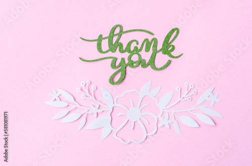 The Thank you text with butterfly paper carve on pastel background. © gamjai