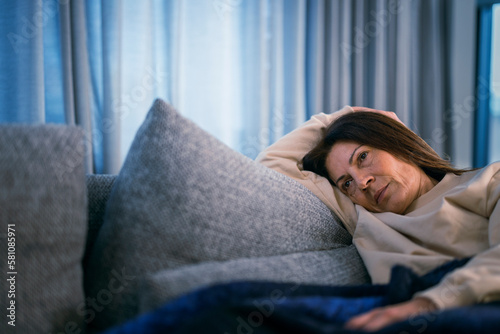 Ill woman lying on sofa