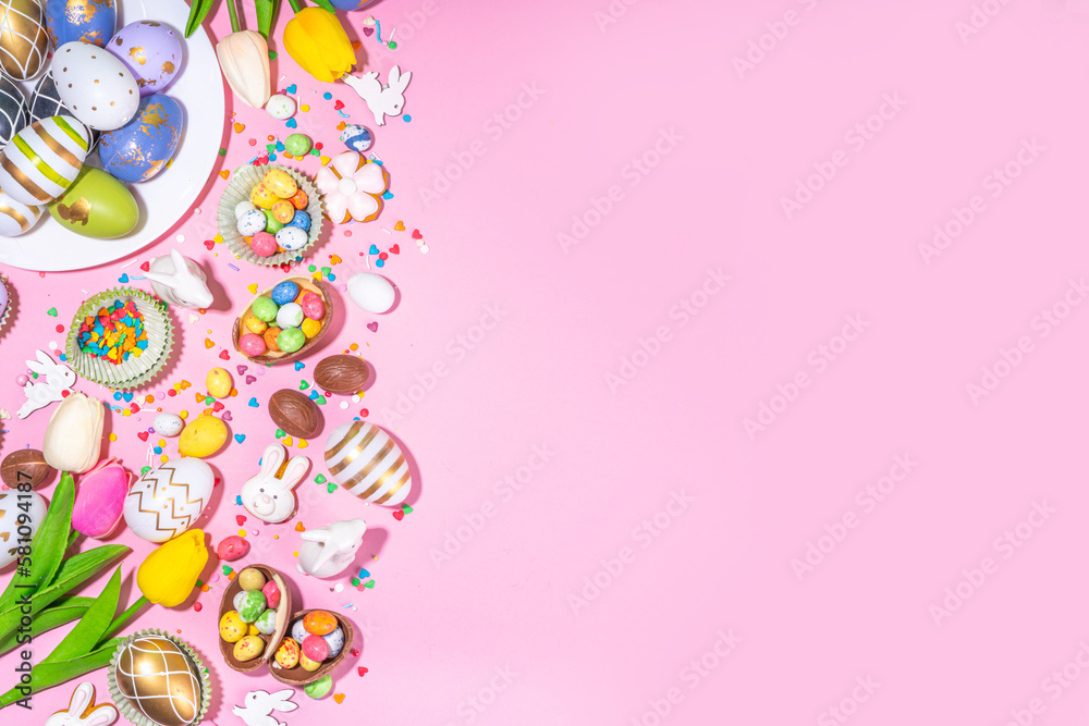 High-colored Easter baking background, Easter sale, party invitation flaylay, Colorful Easter eggs, chocolate eggs and bunny rabbit with sugar sprinkles on bright pink background top view copy space High-colored Easter baking background, Easter sale, party invitation flaylay, Colorful Easter eggs, chocolate eggs and bunny rabbit with sugar sprinkles on bright pink background top view copy space