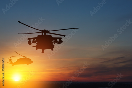 Silhouettes of helicopters on background of sunset. Greeting card for Veterans Day, Memorial Day, Air Force Day. USA celebration. © hamara