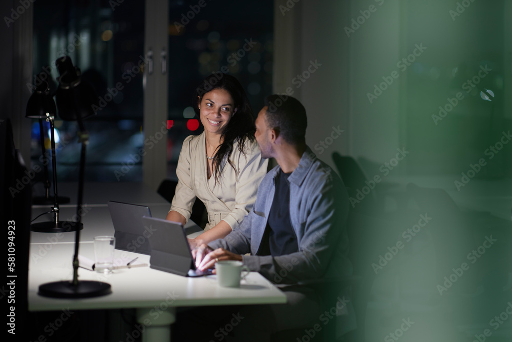 Man and woman working late in office Man and woman working late in office